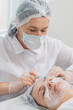 © Andrii Iemelianenko - Beauty anti-aging injections biorevitalization face mesotherapy. Cosmetologist doctor making needle hyaluronic injections syringe into skin of young woman girl. Lifting procedure therapy in clinic
