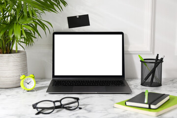 Wall Mural - Office workplace with computer, glasses, houseplant and stationery on marble table near white wall