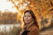 © evgenia_lo - Senior Hispanic woman enjoying the autumn scenery