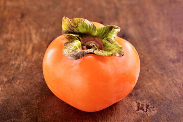 Wall Mural - Delicious ripe persimmon fruit on wooden table.  