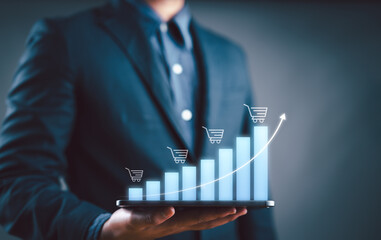 Aufkleber - Sale growth concept. Businessman showing graph of increase in sales volume with shopping cart on virtual screen for ecommerce growth.