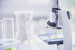 © aFotostock - Science microscope equipment in biology chemical laboratory. Scientific experiment Microscope on Lab table microbiology equipment. Chemistry objects on lab background. Chemistry scientific concept