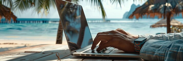 employee working on laptop on the beach during summer vacation