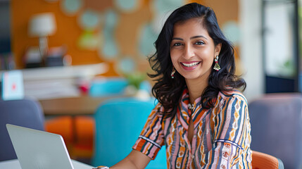 Beautiful Indian girl sitting in front of laptop