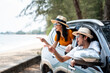 © Chanakon - Young asian couple man and woman travel by car on a bright day to the sea sand beach with beautiful blue sky sunlight. They was happy along the way trip. safety driving car vacation.