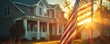 © CHONCHANOK PHOTO - The image shows a beautiful house with an American flag waving in the front yard