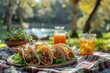 © Мария Фадеева - Outdoor picnic setting with tacos and drinks, capturing a perfect sunny day with natural lighting. Trendy Mexican food.