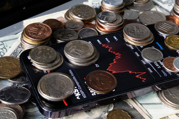 Wall Mural - Various coins and the smartphone on various banknotes