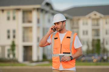 Wall Mural - Serious engineer at new home. Construction manager in helmet. Architect at a construction site. Handyman builder in hardhat. Building concept. Builder foreman.