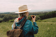 © Westend61 - Stylish woman holding backpack and drinking warm tea