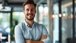 © Prasanth - Portrait of cheerful businessman with arms folded standing in conference room. Happy young business man in shirt looking at camera. Portrait of a smiling businessman in modern office