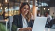 © Nick - Businesswoman working at laptop in coffee shop cafe smile happy focus on work female Caucasian in suit long hair