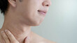 © Summer Paradive - Half face of Asian man touching his neck checking skin crease wrinkles. Facial complexion treatment and rejuvenation by skincare and cosmetic cream. Mens beauty cosmetology. Anti aging concept
