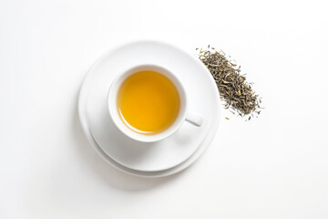 Sticker - A Cup of Tea with Dried Tea Leaves on White Background