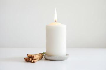 Sticker - White candle burning on a white surface