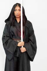 Sci-fi fantasy warrior woman cosplayer in a black robe holding a saber on a white background