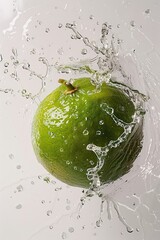 Wall Mural - A lime is being splashed with water, creating a refreshing and invigorating atmosphere. The lime is the main focus of the image, and the water droplets surrounding it add a sense of movement