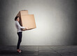 © pathdoc - Business woman carrying large boxes