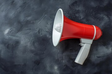 Red and white megaphone on a black chalkboard background, ideal for business announcements and communication themes, flat lay perspective