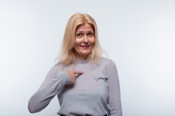 European woman with blond hair is confident in herself on a white background