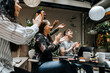© Maskot - Happy male and female business professionals congratulating in team meeting at office