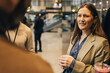 © Maskot - Businesswoman holding glass and discussing with delegates during networking event at convention center