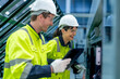 © ultramansk - Male and female engineers in neat work clothes prepare and control the production system of large modern machines in a factory producing industrial technology products.