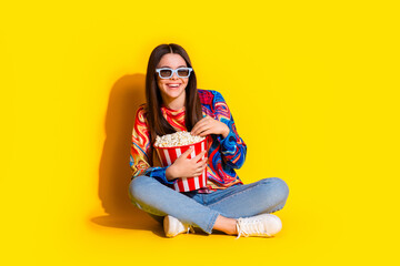 Sticker - Full length photo of lovely young lady eat popcorn watch movie dressed stylish colorful garment isolated on yellow color background