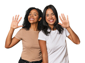 Wall Mural - Young Latin friends in studio showing number ten with hands.