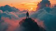 © suteeda - Silhouette of a man on top of a sunset mountain amid clouds.