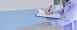 © kanpisut - Doctor filling medical chart, checklist document, patient's information on clipboard. Doctor writing, signing on health insurance document in hospital, healthcare and medicine