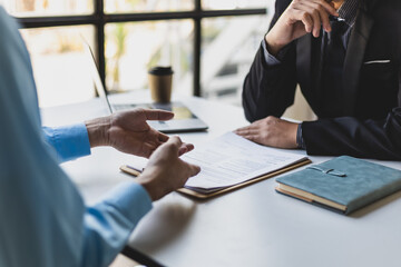 Wall Mural - Job interviews, Employer in suit reading resume of job interview candidate profile collection. Man explaining profile to a manager sitting for a job interview. Job Search and Human Resources