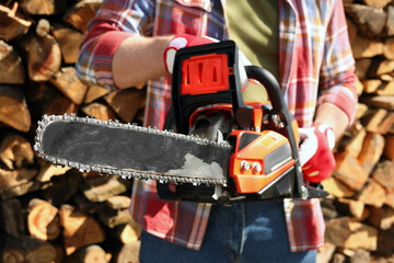 Wall Mural - Man with modern saw on sunny day, closeup