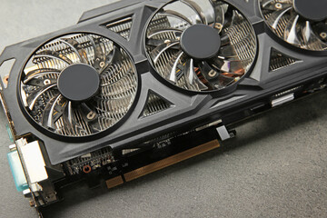Poster - One computer graphics card on grey textured table, closeup