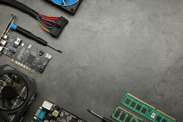 Poster - Graphics card and other computer hardware on grey textured table, flat lay. Space for text