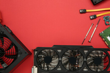 Poster - Graphics card and other computer hardware on red background, flat lay. Space for text