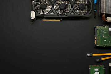 Poster - Graphics card and other computer hardware on black background, flat lay. Space for text