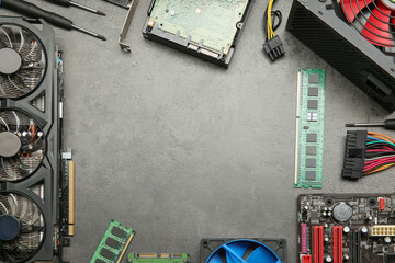 Poster - Frame of graphics card and other computer hardware on grey textured table, flat lay. Space for text