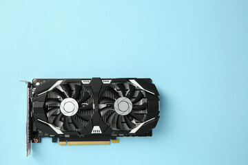 Poster - Computer graphics card on light blue background, top view. Space for text