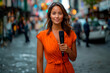 © Favio - 20s beautiful latina woman, journalist at the street, she is wearing orange clothes, holding a microphone