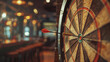 © Ikhou - Darts, arrow hitting target in the center of dartboard with blurred background of sport club interior. success and business goal concept