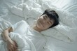 © shobakhul - Asian man 20 yo in a white clothes laying down on white bed with white blanket, happily sleeping