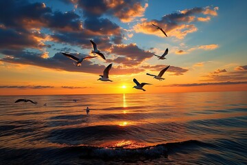 Wall Mural - seagulls fly across the sunset-lit sky