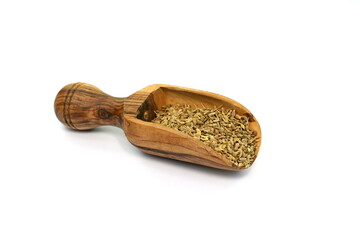 Wall Mural - Dried anise seed (aniseed) in a wooden scoop isolated on white background. 