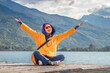© EdNurg - A happy young woman enjoying the stunning view of Lake Plav in Montenegro during summer adventure