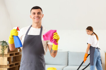 Wall Mural - Male janitor with rag and detergent in room