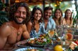 © Design Depot - Group of happy friends sharing a meal and drinks at an outdoor tropical restaurant