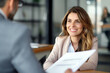 © Danny - Smiling female hr manager hiring recruit at job interview, bank or insurance agent, lawyer making contract deal with client at work.