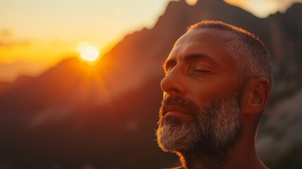 Wall Mural - Back view of a mature man enjoying a sunset in a mountainous landscape, evoking tranquility and contemplation