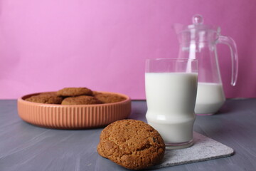 Wall Mural - Healthy Breakfast Concept Biscuits Milk in a Glass Jug on a Pink Background. Healthy food for children